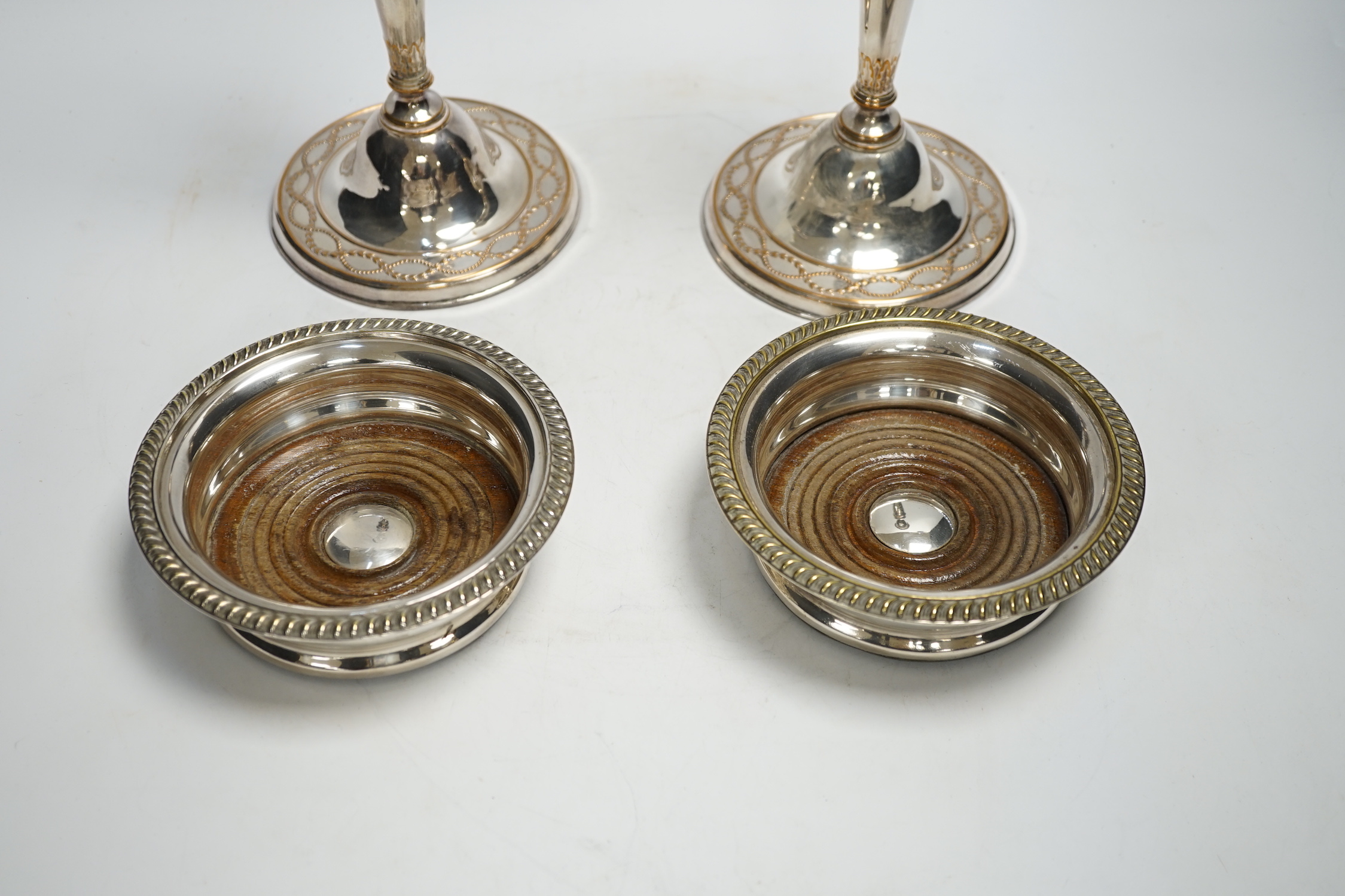 A pair of 19th century silver plated candlesticks and a pair of coasters, tallest 28cm